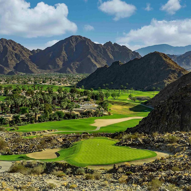 A golf course with mountains in the background.